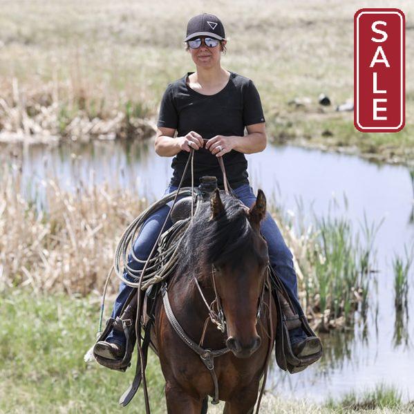 Person riding a horse by a body of water