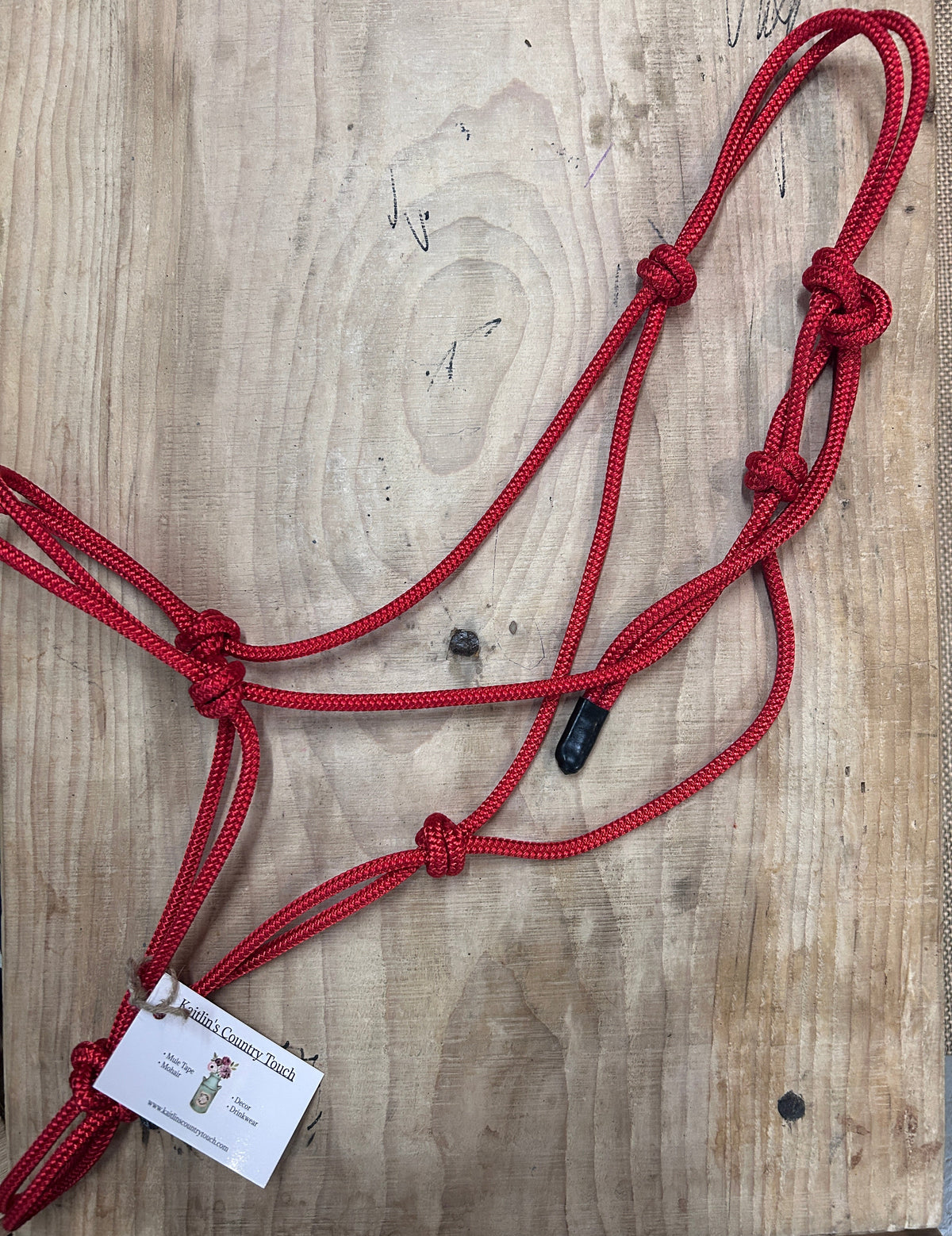 Training Soft Rope Halter for Horses in Red on a wood background
