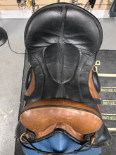 Load image into Gallery viewer, Brown and black leather saddle on a stand with a blurred background
