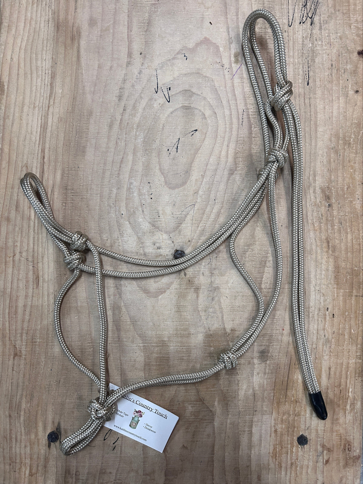 Soft Tan Rope Halter for Horse Training on a wood background