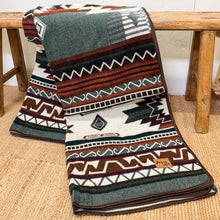 Load image into Gallery viewer, Patterned blanket draped over a wooden bench on a carpeted floor

