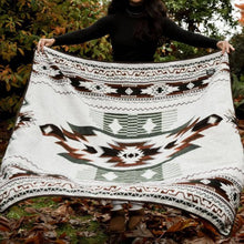 Load image into Gallery viewer, Person holding a patterned blanket outdoors with trees in the background
